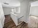 Bright hallway with stairs, wood-look flooring, and neutral paint, offering a welcoming transition between levels at 7140 Stonington Ln, Charlotte, NC 28227