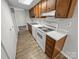 Functional kitchen with white appliances, wood cabinetry, and ample countertop space for easy meal prep at 7140 Stonington Ln, Charlotte, NC 28227