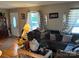 Inviting living room with hardwood floors, large window, and comfortable seating area at 7426 Riding Trail Rd, Charlotte, NC 28212