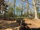 Large backyard featuring trees, a shed, and plenty of space for outdoor activities at 7515 Riding Trail Rd, Charlotte, NC 28212