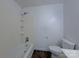 Simple bathroom featuring a standard bathtub, toilet, tiled flooring, and shower at 7515 Riding Trail Rd, Charlotte, NC 28212
