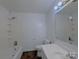 Clean bathroom features a bathtub, toilet, vanity, and tiled flooring at 7515 Riding Trail Rd, Charlotte, NC 28212