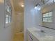 Small bathroom with vanity, mirror, and tiled shower with glass doors at 7515 Riding Trail Rd, Charlotte, NC 28212