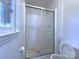 Modest bathroom featuring a tiled shower with sliding glass doors at 7515 Riding Trail Rd, Charlotte, NC 28212
