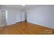 Spacious bedroom with hardwood floors, closet, and neutral paint at 7515 Riding Trail Rd, Charlotte, NC 28212
