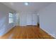 Bedroom featuring hardwood floors and natural light through the windows at 7515 Riding Trail Rd, Charlotte, NC 28212
