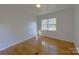Bright bedroom featuring hardwood floors and a window providing natural light at 7515 Riding Trail Rd, Charlotte, NC 28212