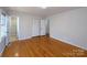 Bedroom with wood floors, closet, and access to the bathroom at 7515 Riding Trail Rd, Charlotte, NC 28212