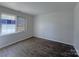 Simple bedroom with neutral walls and a window providing natural light at 7515 Riding Trail Rd, Charlotte, NC 28212