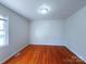 Bright bedroom with hardwood floors, a window, and neutral walls at 7515 Riding Trail Rd, Charlotte, NC 28212