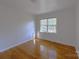 Bright bedroom featuring hardwood floors and a window providing natural light at 7515 Riding Trail Rd, Charlotte, NC 28212