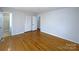 Bedroom with wood floors, closet, and access to the bathroom at 7515 Riding Trail Rd, Charlotte, NC 28212
