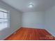 Cozy bedroom with natural light, hardwood floors, and a minimalist aesthetic at 7515 Riding Trail Rd, Charlotte, NC 28212