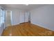 Bedroom featuring wood floors with an ensuite and closet space at 7515 Riding Trail Rd, Charlotte, NC 28212