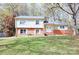 Charming two-story home featuring a brick facade, a walkway, and a well-manicured lawn at 7515 Riding Trail Rd, Charlotte, NC 28212