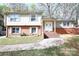 Charming two-story home featuring a brick facade, a walkway, and a well-manicured lawn at 7515 Riding Trail Rd, Charlotte, NC 28212
