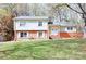 Charming two-story home featuring a well-manicured lawn and a classic brick and siding facade at 7515 Riding Trail Rd, Charlotte, NC 28212