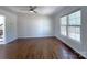 Spacious living room with hardwood floors, a ceiling fan, and a large window at 7515 Riding Trail Rd, Charlotte, NC 28212
