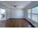 Spacious living room with hardwood floors, a ceiling fan, and a large window at 7515 Riding Trail Rd, Charlotte, NC 28212
