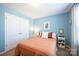 Cozy bedroom with blue walls, double closets, and neutral accents at 7672 Tanglewood Way, Denver, NC 28037