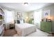 Bright bedroom with soft green walls, white trim, and neutral carpet at 7672 Tanglewood Way, Denver, NC 28037