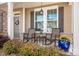 Charming front porch featuring rocking chairs, beautiful flower arrangements and craftsman style architecture at 7672 Tanglewood Way, Denver, NC 28037