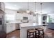 Bright kitchen with stainless steel appliances, white cabinets, granite countertops, large island with seating and hardwood floors at 7672 Tanglewood Way, Denver, NC 28037