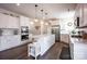 Spacious modern kitchen with stainless appliances, granite countertops, large island and pendant lighting at 7672 Tanglewood Way, Denver, NC 28037