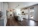 Open-concept kitchen with stainless steel appliances, white cabinets, large island with seating at 7672 Tanglewood Way, Denver, NC 28037