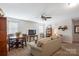 Inviting living room featuring neutral tones, a ceiling fan, and cozy seating for relaxing and entertaining at 7672 Tanglewood Way, Denver, NC 28037