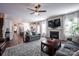Spacious open-concept living room with fireplace, large windows, hardwood floors, and adjoined kitchen at 7672 Tanglewood Way, Denver, NC 28037