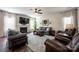 Comfortable living room featuring a fireplace, large windows, hardwood floors, neutral paint and ample seating at 7672 Tanglewood Way, Denver, NC 28037