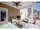 Relaxing covered patio with comfortable seating, a ceiling fan, and outdoor cooking area perfect for entertaining at 7672 Tanglewood Way, Denver, NC 28037