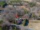 An aerial view of a single-Gathering home nestled among trees, with road access and a generous lot at 8080 Monbo Rd, Catawba, NC 28609