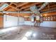 Spacious unfinished basement with exposed ceiling, utility pipes, and a staircase, ready for your personal touch at 8080 Monbo Rd, Catawba, NC 28609