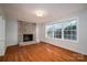 Inviting living room featuring hardwood floors, a cozy brick fireplace, and ample natural light at 8080 Monbo Rd, Catawba, NC 28609