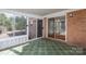 Bright sunroom with tile flooring, offering views and access to the outdoors through sliding glass doors at 8080 Monbo Rd, Catawba, NC 28609