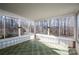 Sunroom with tile flooring, surrounded by windows offering natural light and views of wooded area at 8080 Monbo Rd, Catawba, NC 28609