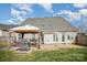 Expansive backyard showcasing a patio with outdoor seating, grilling area and lush green grass at 8603 Ridgeline Ln, Charlotte, NC 28269