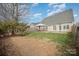 Spacious backyard with a patio featuring a covered seating area and a well-manicured lawn at 8603 Ridgeline Ln, Charlotte, NC 28269