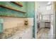 Chic bar area features granite countertops and modern decorative wallpaper at 8603 Ridgeline Ln, Charlotte, NC 28269