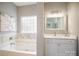 Bathroom featuring a soaking tub, white cabinets, and a granite countertop at 8603 Ridgeline Ln, Charlotte, NC 28269