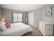 Carpeted bedroom with a large window, neutral walls, and a modern paint scheme at 8603 Ridgeline Ln, Charlotte, NC 28269