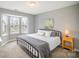 Cozy bedroom with a bay window, natural light, carpet, and an art collection at 8603 Ridgeline Ln, Charlotte, NC 28269