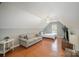 Bright bedroom featuring a full size bed, a seating area, and natural light at 8603 Ridgeline Ln, Charlotte, NC 28269