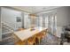 Bright and airy dining room with a large table, stylish chairs, and bay windows with decorative curtains at 8603 Ridgeline Ln, Charlotte, NC 28269
