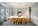 Inviting dining room featuring a spacious table, modern lighting fixture, and large windows with decorative curtains at 8603 Ridgeline Ln, Charlotte, NC 28269