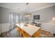 Inviting dining room featuring a spacious table, modern lighting fixture, and large windows with decorative curtains at 8603 Ridgeline Ln, Charlotte, NC 28269