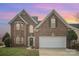 Charming two-story brick home featuring a two-car garage, arched windows and a landscaped front yard at 8603 Ridgeline Ln, Charlotte, NC 28269