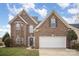 Charming two-story brick home featuring a two-car garage, arched windows and a landscaped front yard at 8603 Ridgeline Ln, Charlotte, NC 28269